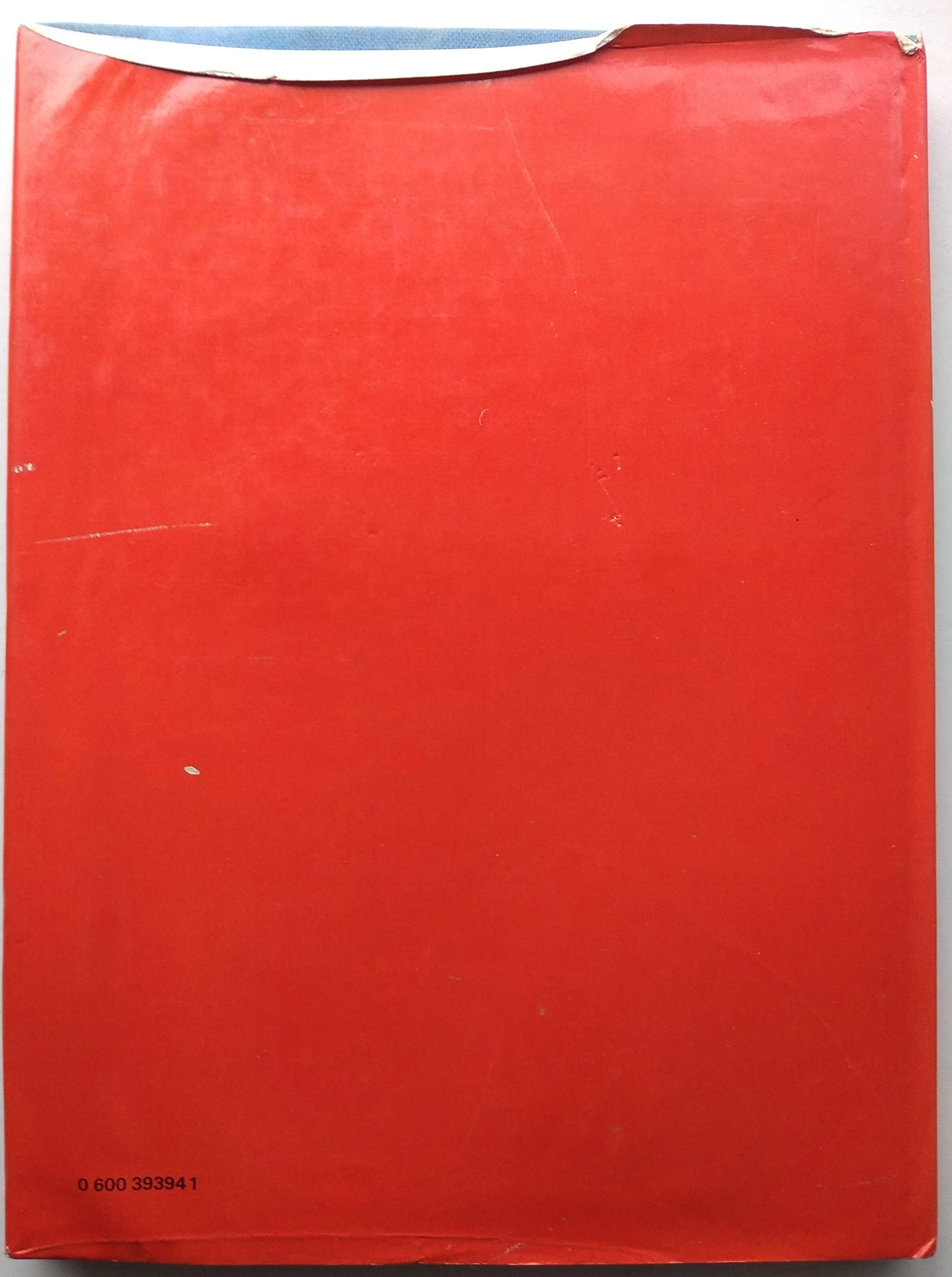 A red book dustcover, photographed against a light background.